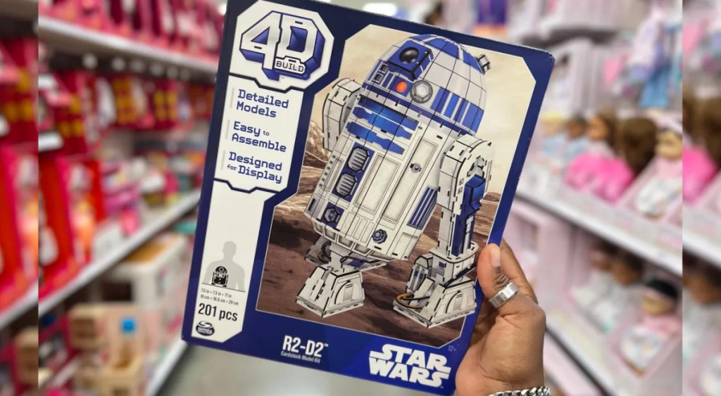 holding a box of Star Wars 4D Build R2-D2 
