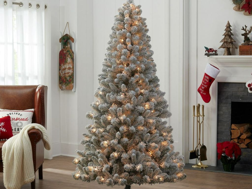 image of Holiday Time 6.5 ft Pre-Lit Flocked Frisco Pine Artificial Christmas Tree w/ Clear Lights in living room
