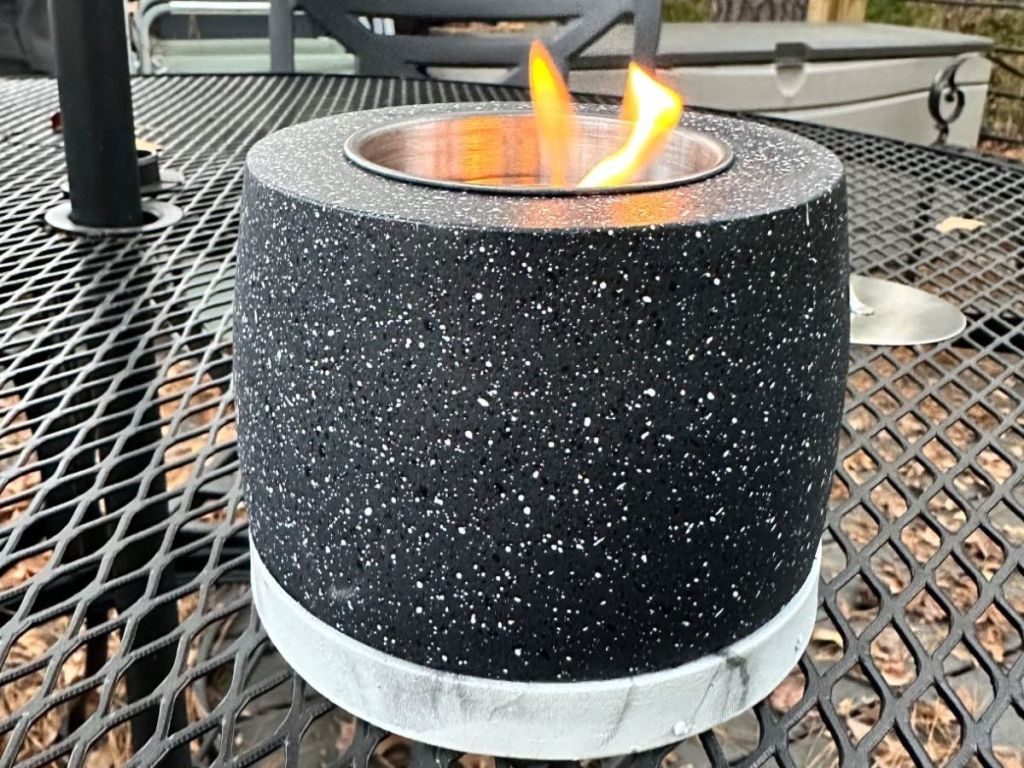 black white speckled mini tabletop firepit sitting on outdoor table