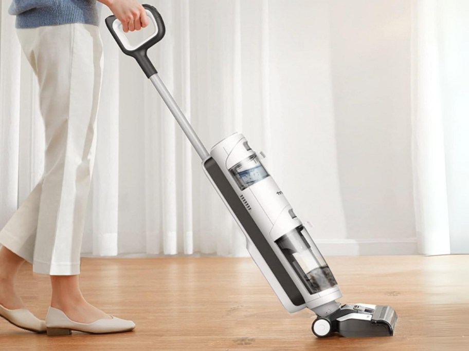 woman vacuuming hard flood floor with Tineco wet dry vacuum