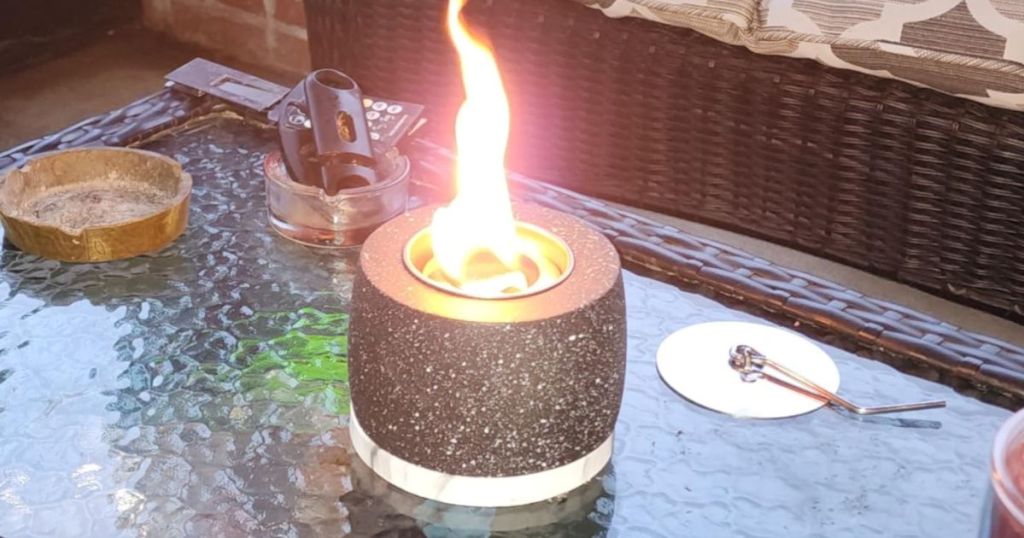 black white speckled mini tabletop firepit sitting on outdoor table