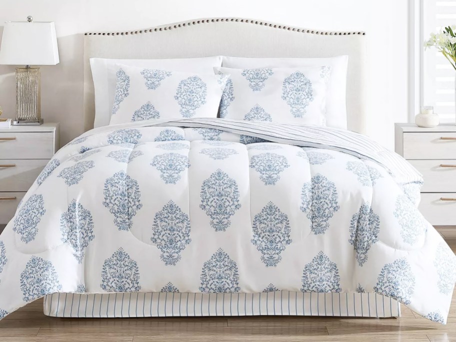 white and blue medallion print comforter on bed