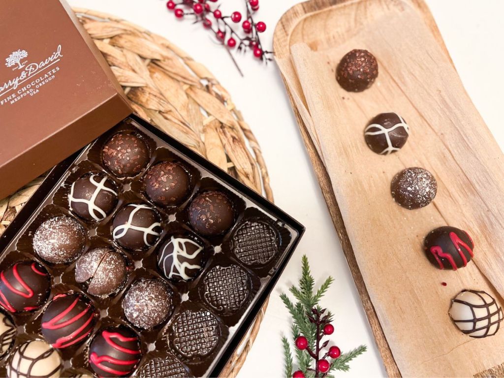 A box of Harry & David Truffles with each flavor on a board next to the box