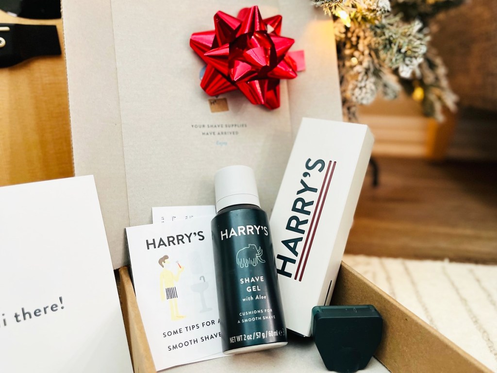 opened box with harry's shave products inside and red bow on top