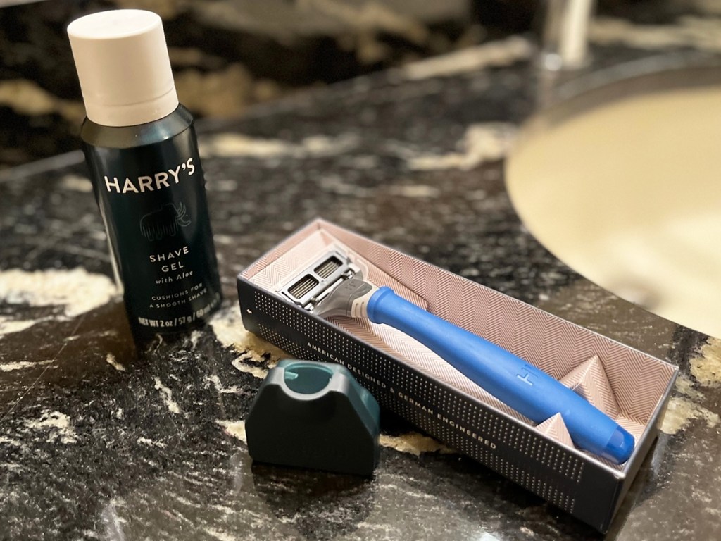 blue razor and shave gel on bathroom counter