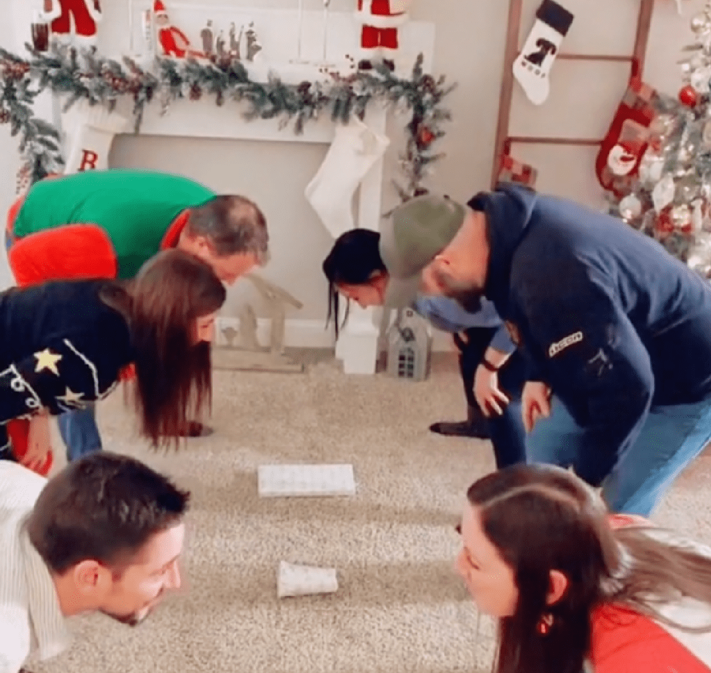 Family playing the Head, Shoulders, Gift game on Christmas