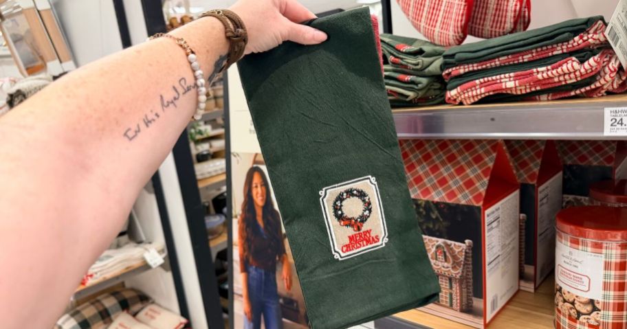 hand holding Hearth & Hand with Magnolia Happy Holidays Kitchen Towel 2-Pack in store