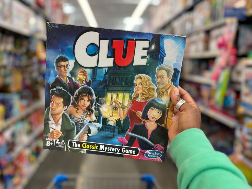 Clue Board Game in person's hand at Walmart