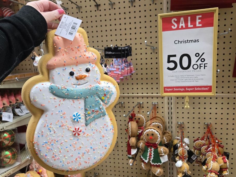 Hobby Lobby Christmas Decor next to a sign showing 50% off