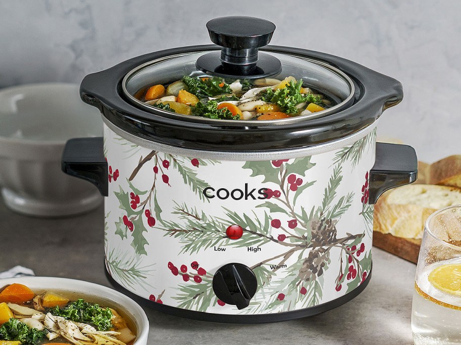 Holiday Slow Cooker in Holly Berry displayed next to the table