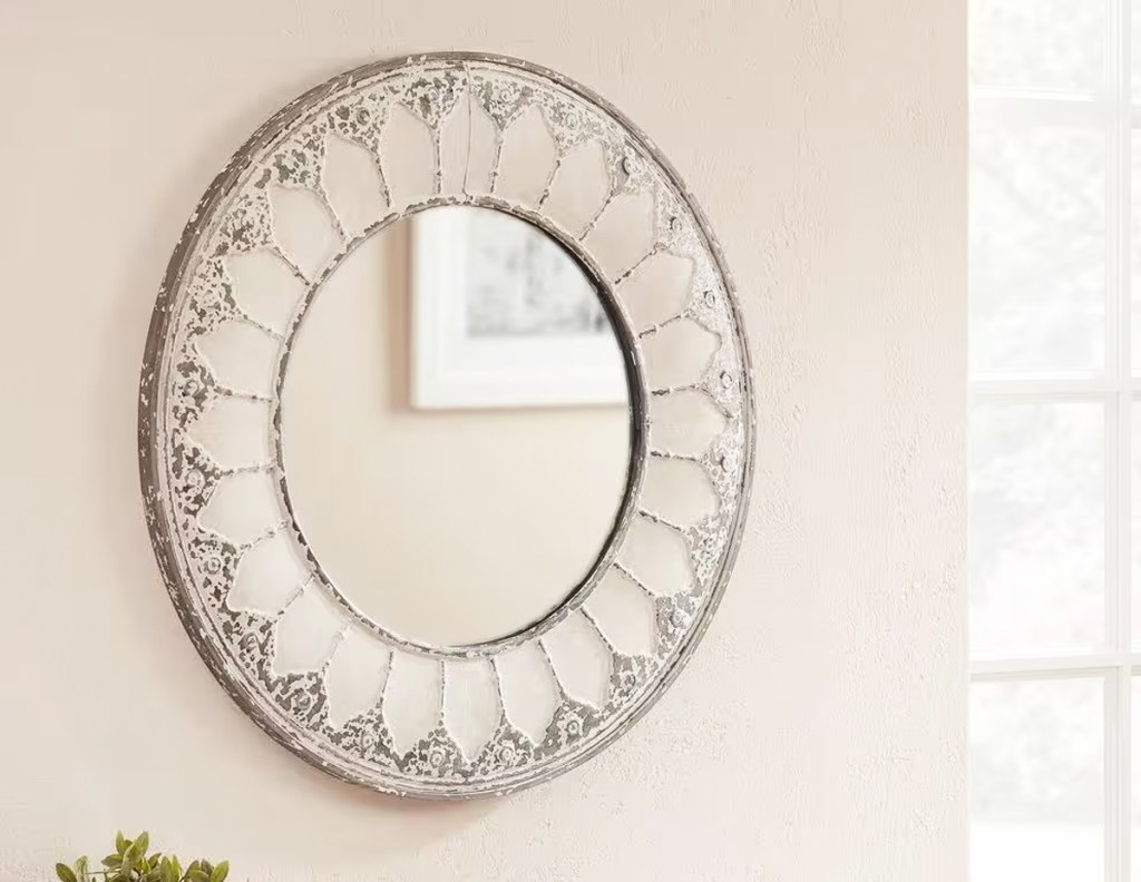 round antiqued mirror on wall