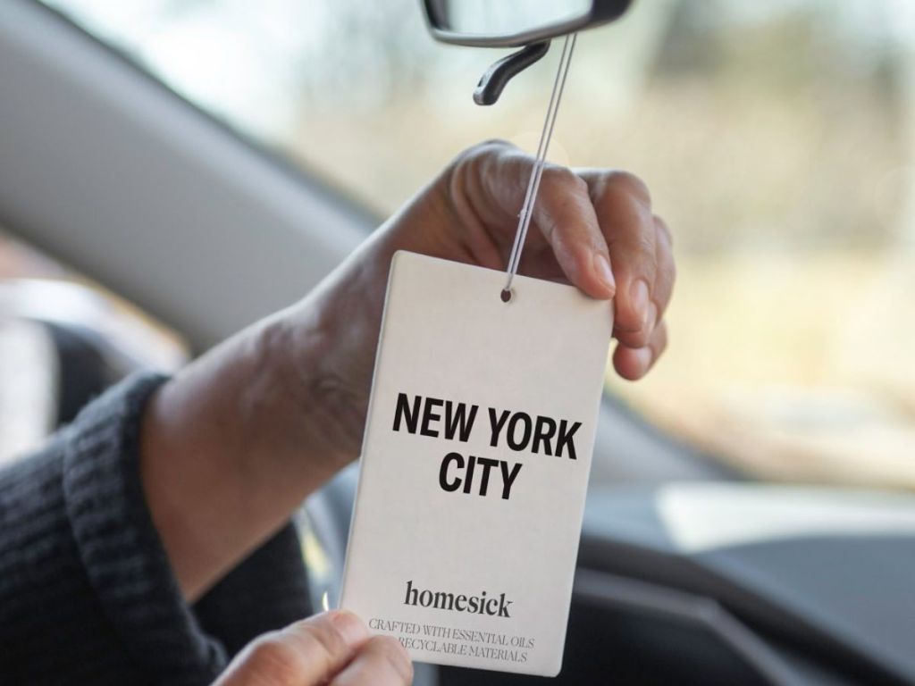 Homesick New york Car Freshener hanging from a rearview mirror