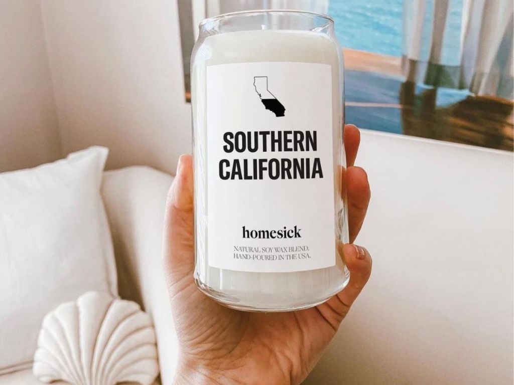 Hand holding up a Homesick SoCal Candle
