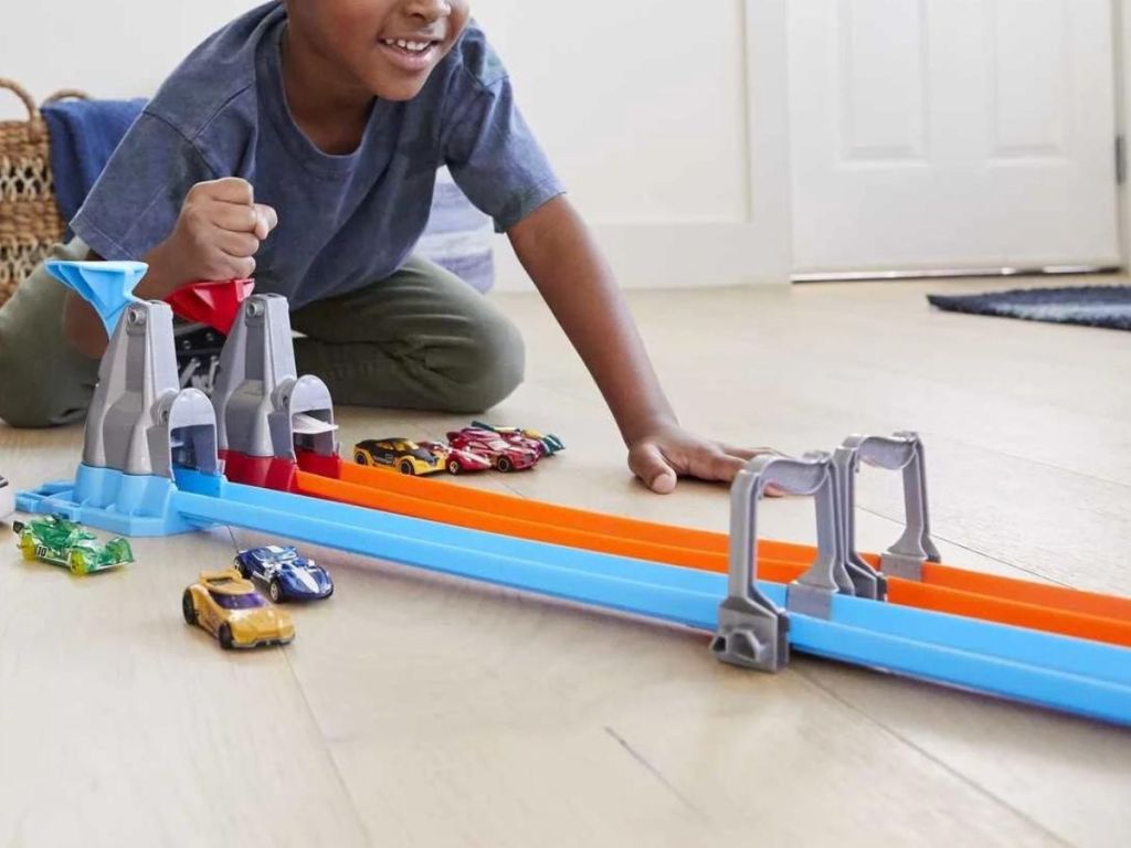 Child playing with the hot wheels double loop track set