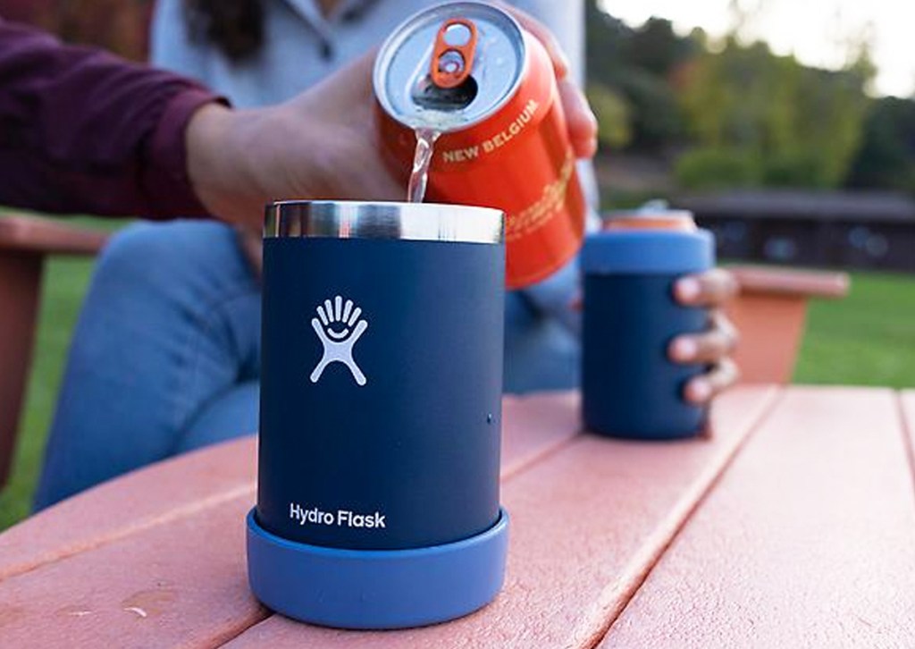pouring can into blue hydroflask cup