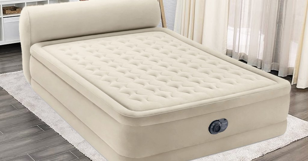 tan air mattress with built in headboard in a living room