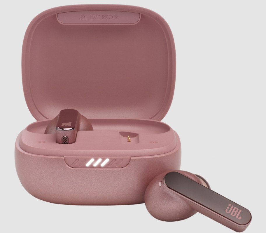 rose pink earbuds next to charging case