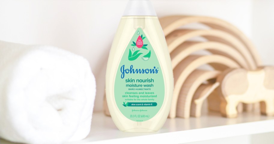bottle of Johnson's baby wash on shelf near rolled towel