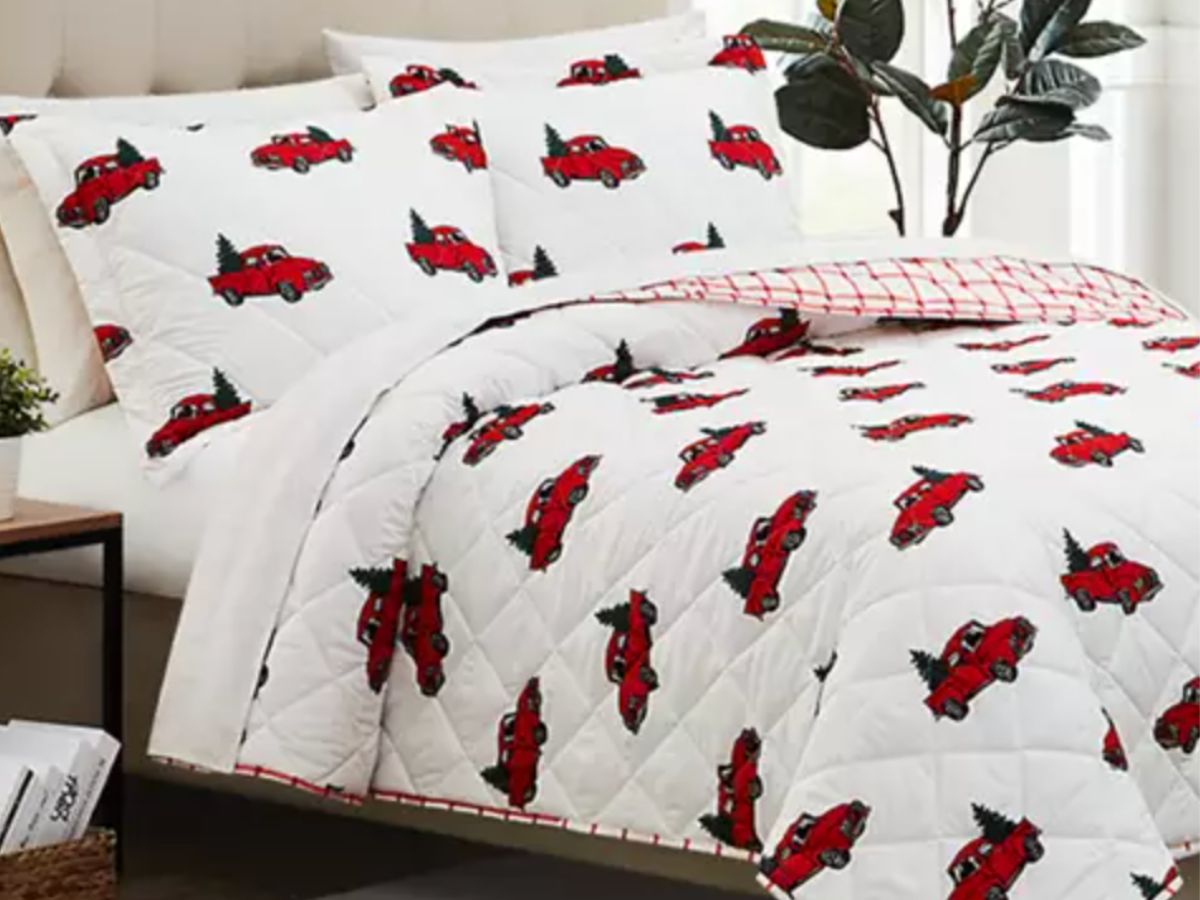 Joyland holiday quilt set with red trucks on it