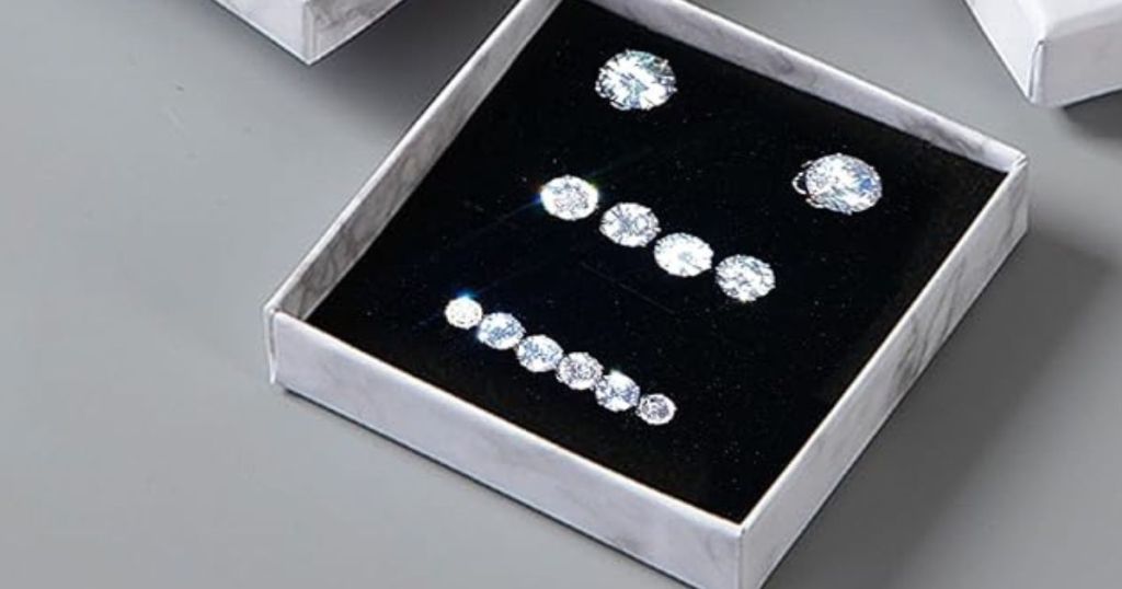 many pairs of sparkly stud earrings in box