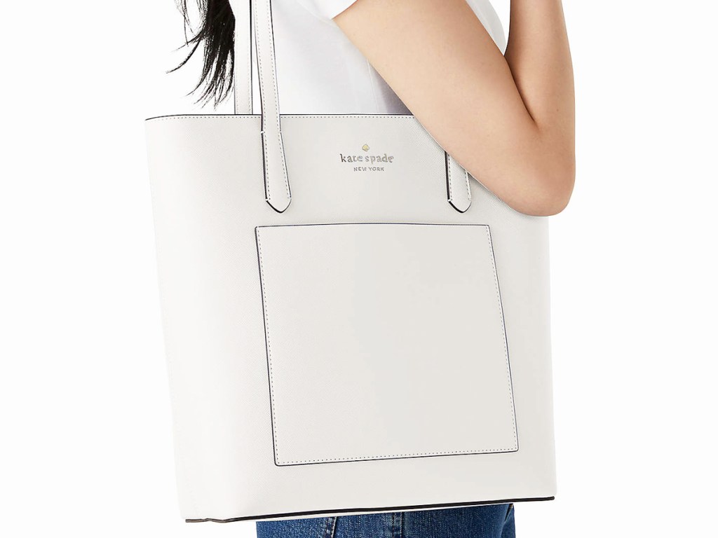 woman with a white kate spade tote bag