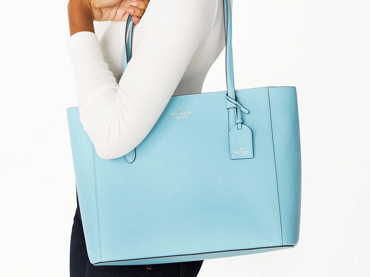 woman with light blue tote bag