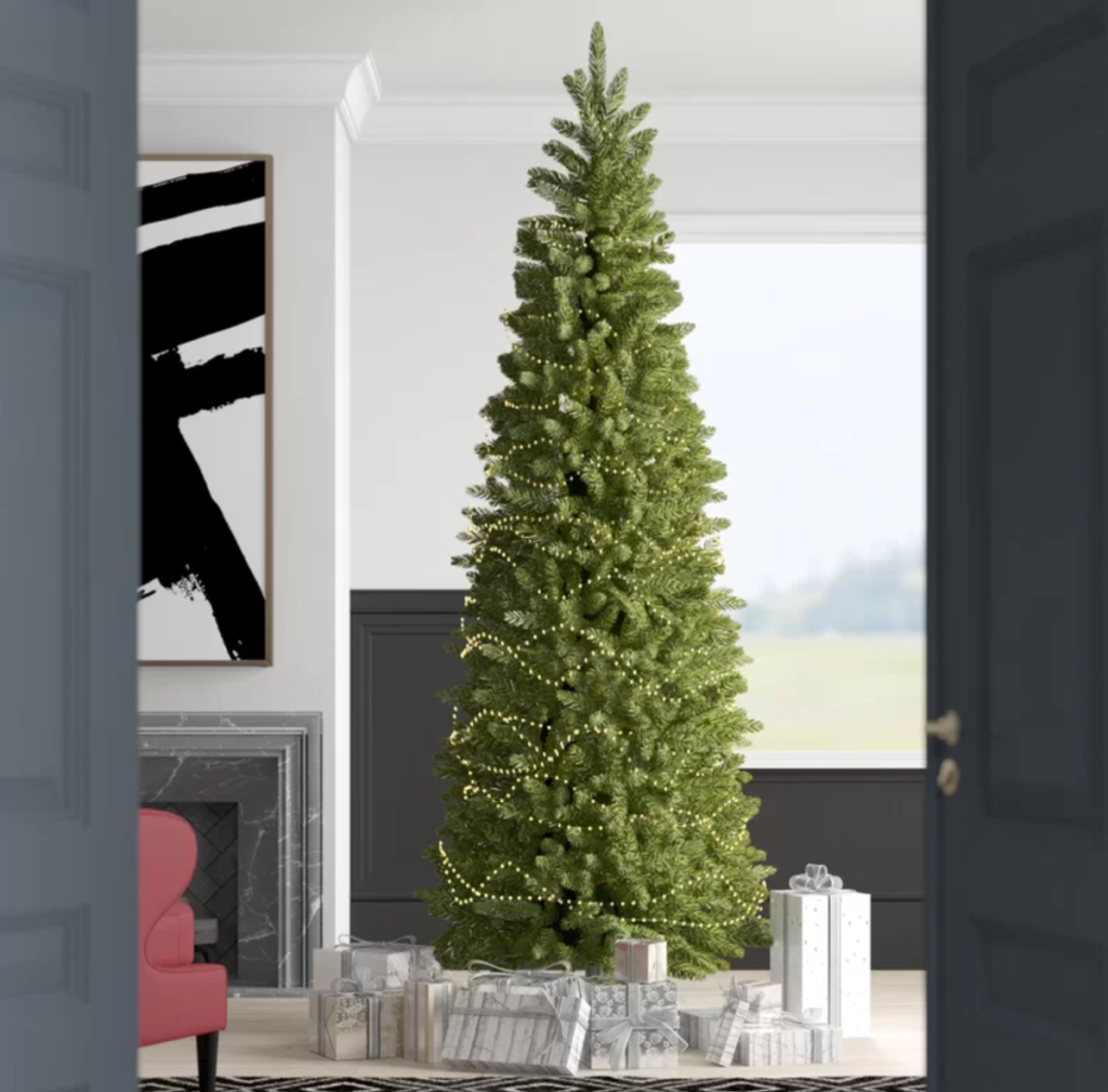 A Kingswood Fir Christmas Tree from Wayfair set up in a living room
