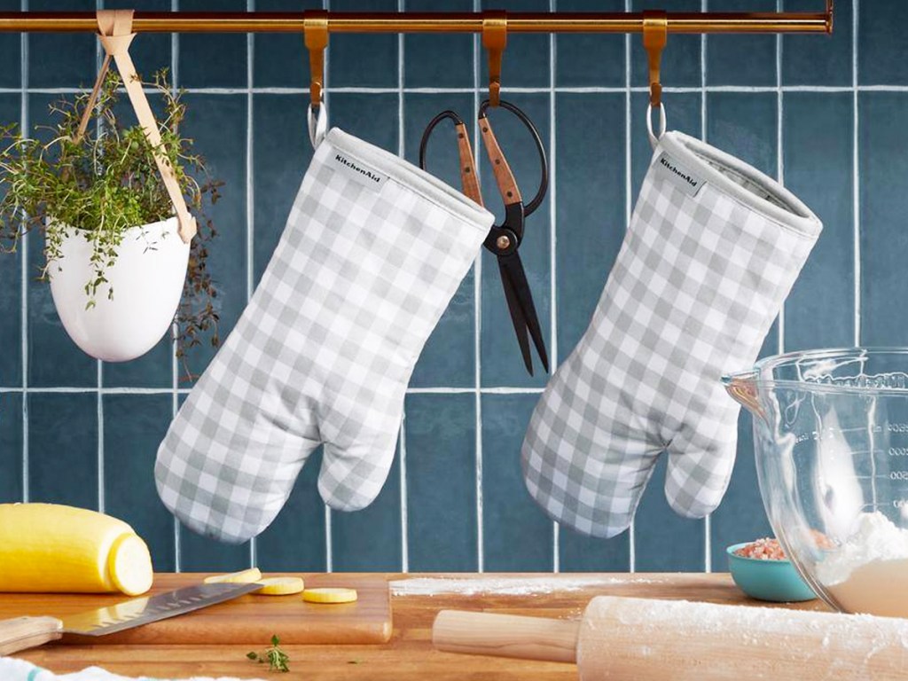 grey and white gingham print pot holders hanging in kitchen