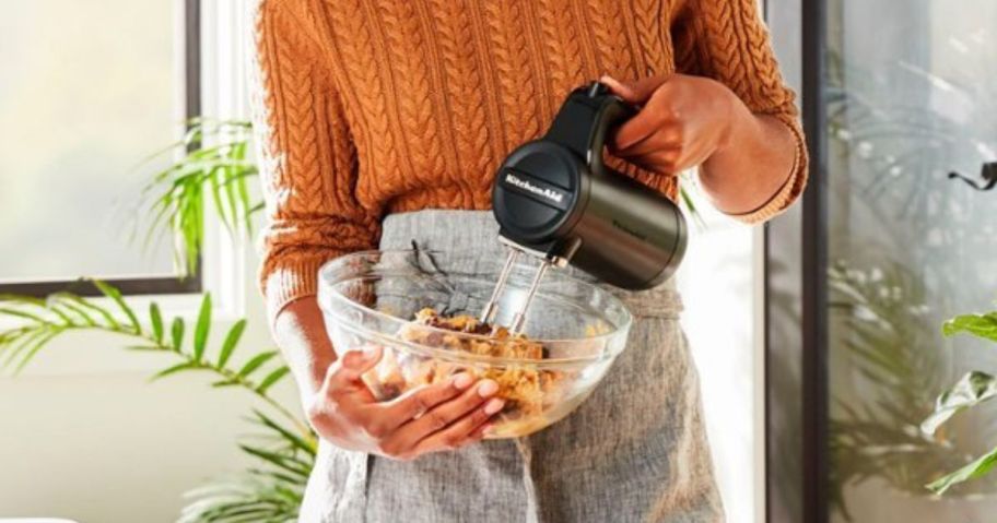 Woman mixing a bowl of cookie batter with a Kitchenaid Cordless Mxer