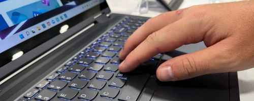 Hand touching the keyboard on a lenovo laptop