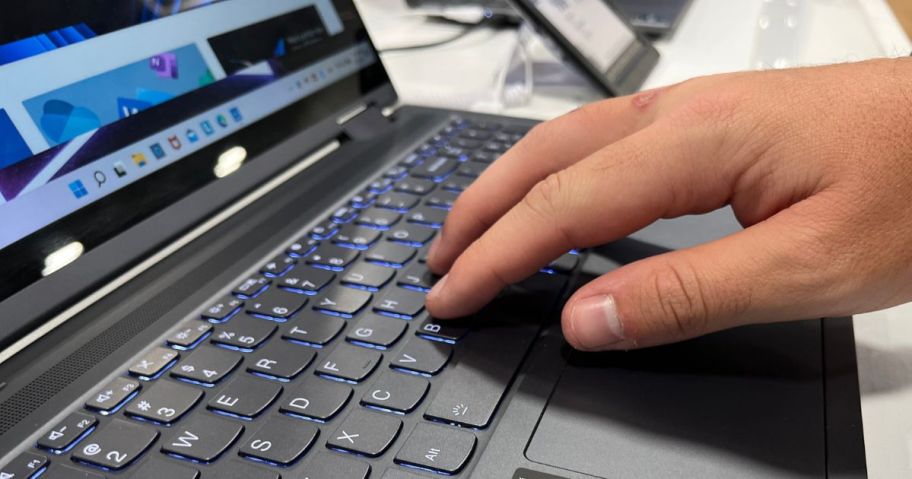 Hand touching the keyboard on a lenovo laptop