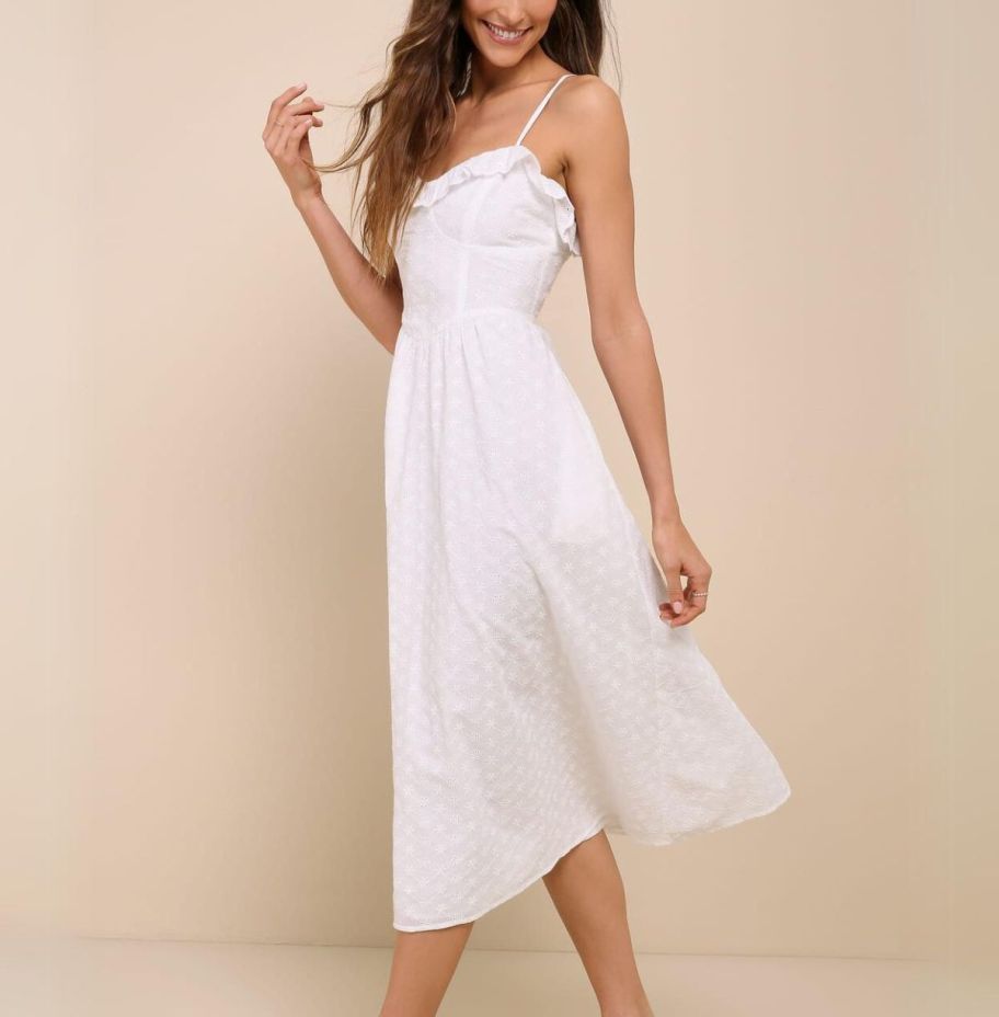 a model wearing a white bustier midi dress