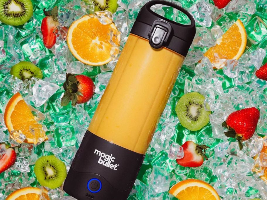 A Magic Bullet Portable Blender in a bath of ice and fruit