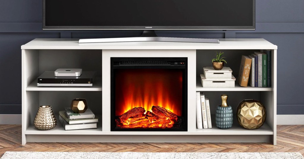 white tv stand with built-in fireplace in center
