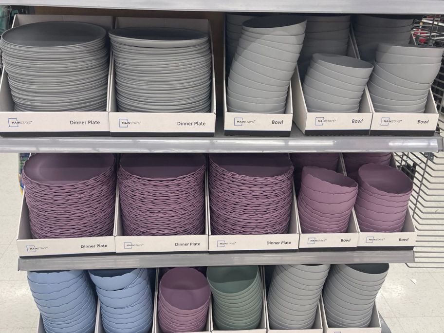 gray, purple, blue and green plastic plates and bowls on store shelf