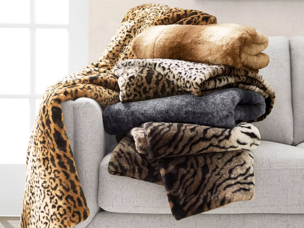 faux fur blankets piled on couch