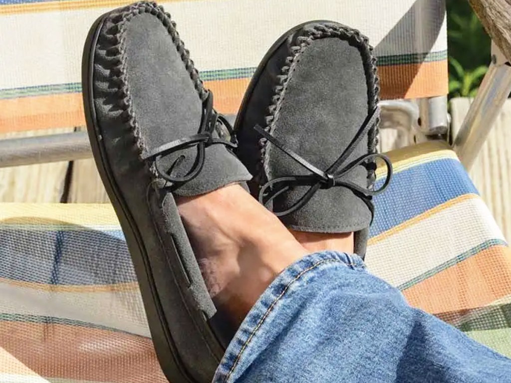 man wearing a pair of grey moccasin slippers