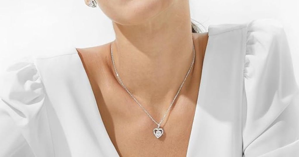 woman wearing a heart necklace with gem