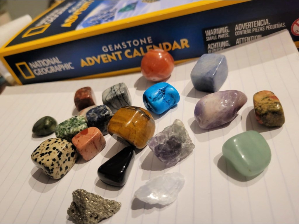 rocks displayed on paper in front of National Geographic Gemstone Advent Calendar