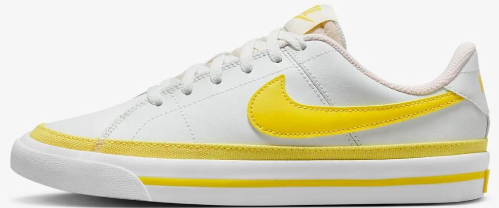 white and yellow nike shoe
