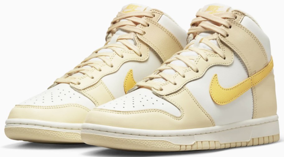 pair of tan, white, and yellow high top nike sneakers