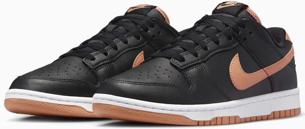 pair of black sneakers with tan nike logo