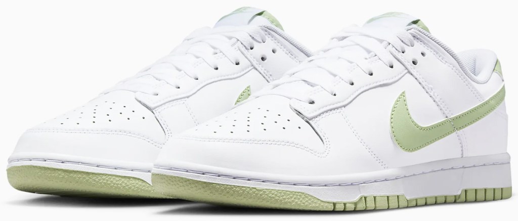 white sneakers with light green nike logo and soles