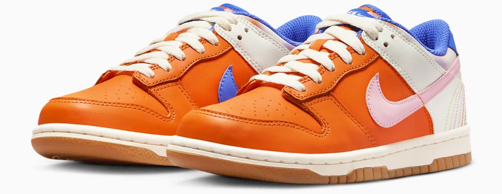 pair of orange, white, blue, and light pink nike sneakers