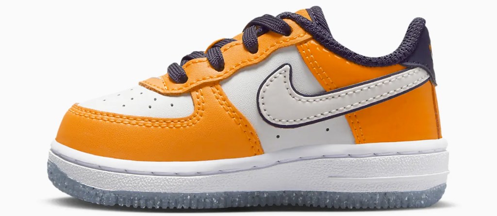 orange and white nike baby shoe