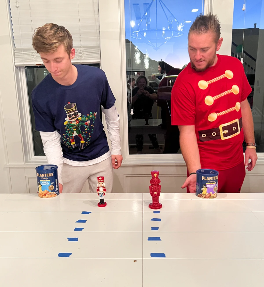 Two men playing Nut Flipper, a family Christmas game