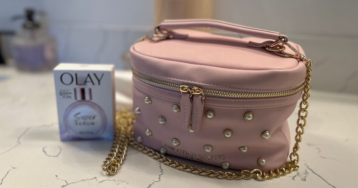 pink Christian Siriano makeup bag with Olay Super Serum beside it