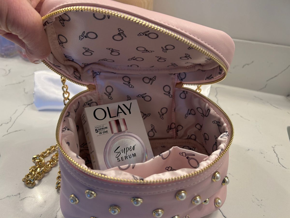 pink makeup bag unzipped revealing Olay Super Serum