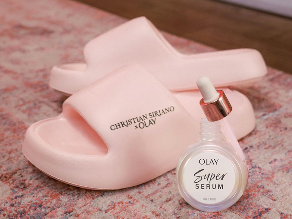 Olay Super Serum Bottle next to pink Christian Siriano X Olay Slides