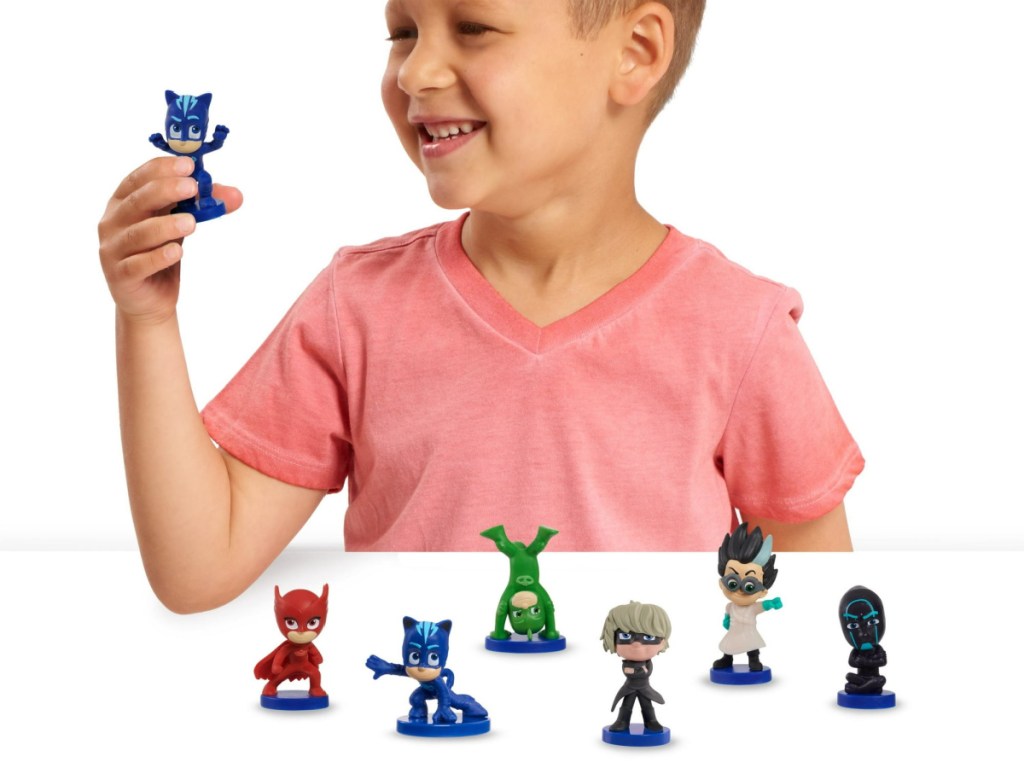 boy playing with PJ Masks Collectible Figures